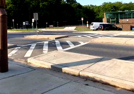 these 3 photos all show an intersection with a crosswalk from various angles.  The street is 5 lanes wide, including 2 parking lanes.  The crosswalk on one side of the street crosses 2 lanes (one of which is the parking lane), then passes through a refuge island that fills the middle lane, crosses one more lane and then passes through a bulbout (an extension of the sidewalk into the street) which blocks the parking lane